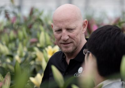 Collegue form Aker talking with customer between lilies